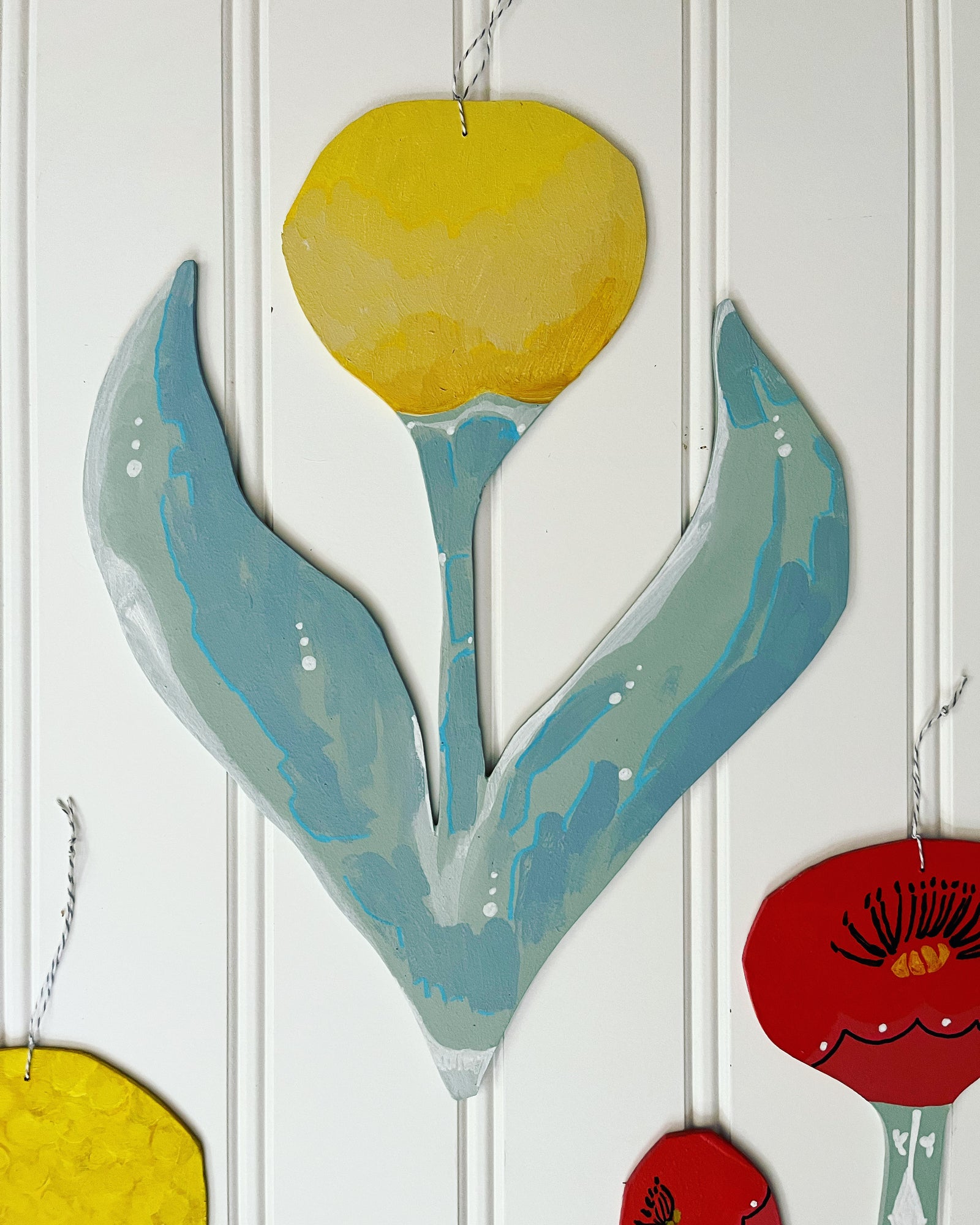 cutout wooden flower painting, by artist Abigail Gray Swartz. Tall yellow flower, acrylic on panel.